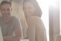 Couple smiling at breakfast table — Stock Photo