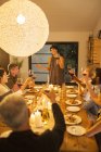 Woman giving toast at dinner party — Stock Photo