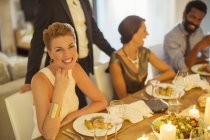 Woman smiling at dinner party — Stock Photo