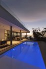 Tranquila piscina de regazo azul fuera de la moderna casa de lujo escaparate exterior - foto de stock