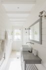 Long, sunny white modern luxury bathroom — Stock Photo