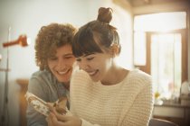 Smiling young couple opening birthday gift — Stock Photo