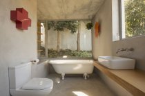 Modern, minimalist luxury bathroom with soaking tub and windows — Stock Photo