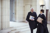 Judges walking through courthouse together — Stock Photo