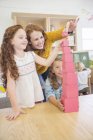 Students and teacher stacking blocks in classroom — Stock Photo