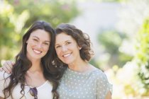 Happy caucasian mother and daughter smiling outdoors — Stock Photo