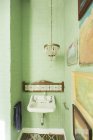 Sink and chandelier in rustic bathroom — Stock Photo
