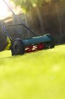 Close up of lawnmower on green lawn — Stock Photo