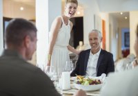 Couple laughing at dinner party — Stock Photo