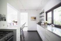 Counters and breakfast bar in modern kitchen — Stock Photo