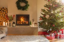 Chimenea ambiental y árbol de Navidad en el salón - foto de stock