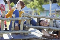 Teacher and students playing on play structure — Stock Photo
