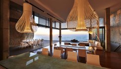 Pendant lights hanging in modern luxury house with ocean view — Stock Photo