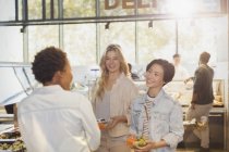 Young women friends at salad bar in grocery store market — Stock Photo