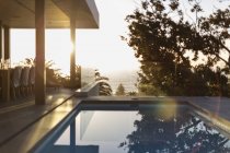 Tranquil lap swimming pool on sunset patio — Stock Photo