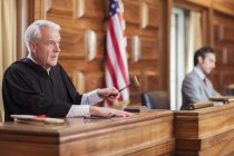 Judge banging gavel in court — Stock Photo
