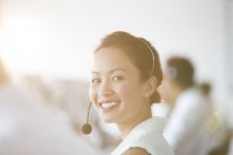 Businesswoman wearing headset in office — Stock Photo
