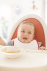Baby boy crying in high chair — Stock Photo