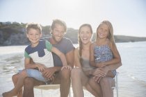Family sitting together in waves — Stock Photo