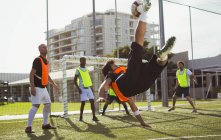 Soccer player kicking over back ball — Stock Photo