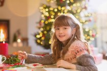 Portrait smiling girl making Christmas decorations — Stock Photo