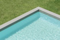 Sunny view of swimming pool in backyard — Stock Photo