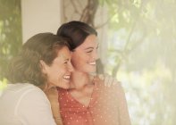 Happy beautiful mother and daughter hugging outdoors — Stock Photo