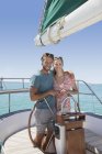 Couple steering sailboat together — Stock Photo