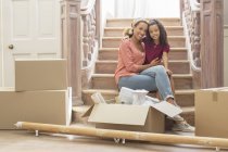 Mother and daughter hugging on stairs — Stock Photo