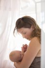 Brunette mother breast-feeding baby girl — Stock Photo