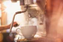 Close up espresso machine filling coffee cup with hot water — Stock Photo