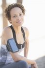 Portrait of confident female jogger wearing arm band — Stock Photo
