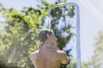 Woman showering outdoors during daytime — Stock Photo