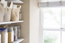 Dry goods and window of pantry — Stock Photo