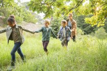 Students and teacher walking outdoors — Stock Photo