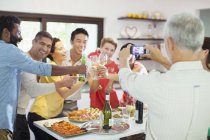 Man taking picture of friends at party — Stock Photo