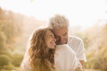 Affectionate couple hugging and smiling — Stock Photo