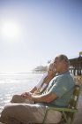 Senior couple relaxing in lawn chairs on beach — Stock Photo