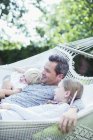 Father and children relaxing in hammock — Stock Photo