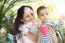 Mother holding baby girl outdoors — Stock Photo