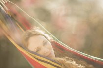 Portrait serene woman relaxing laying in hammock — Stock Photo