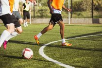 Crop soccer players training on field — Stock Photo