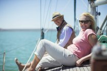 Couple relaxing on deck of sailboat — Stock Photo