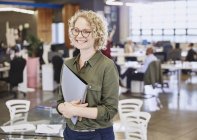 Smiling caucasian businesswoman at modern office — Stock Photo