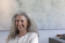 Зрелая женщина смеется с закрытыми глазами — стоковое фото
