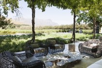 Armchairs and sofa on modern patio overlooking vineyard — Stock Photo