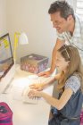 Father and daughter using computer together — Stock Photo