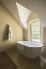 Bath against window at luxury modern house — Stock Photo