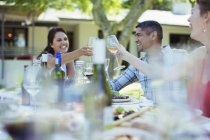 Friends toasting each other at dinner outdoors — Stock Photo