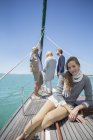 Girl sitting on deck of sailboat — Stock Photo